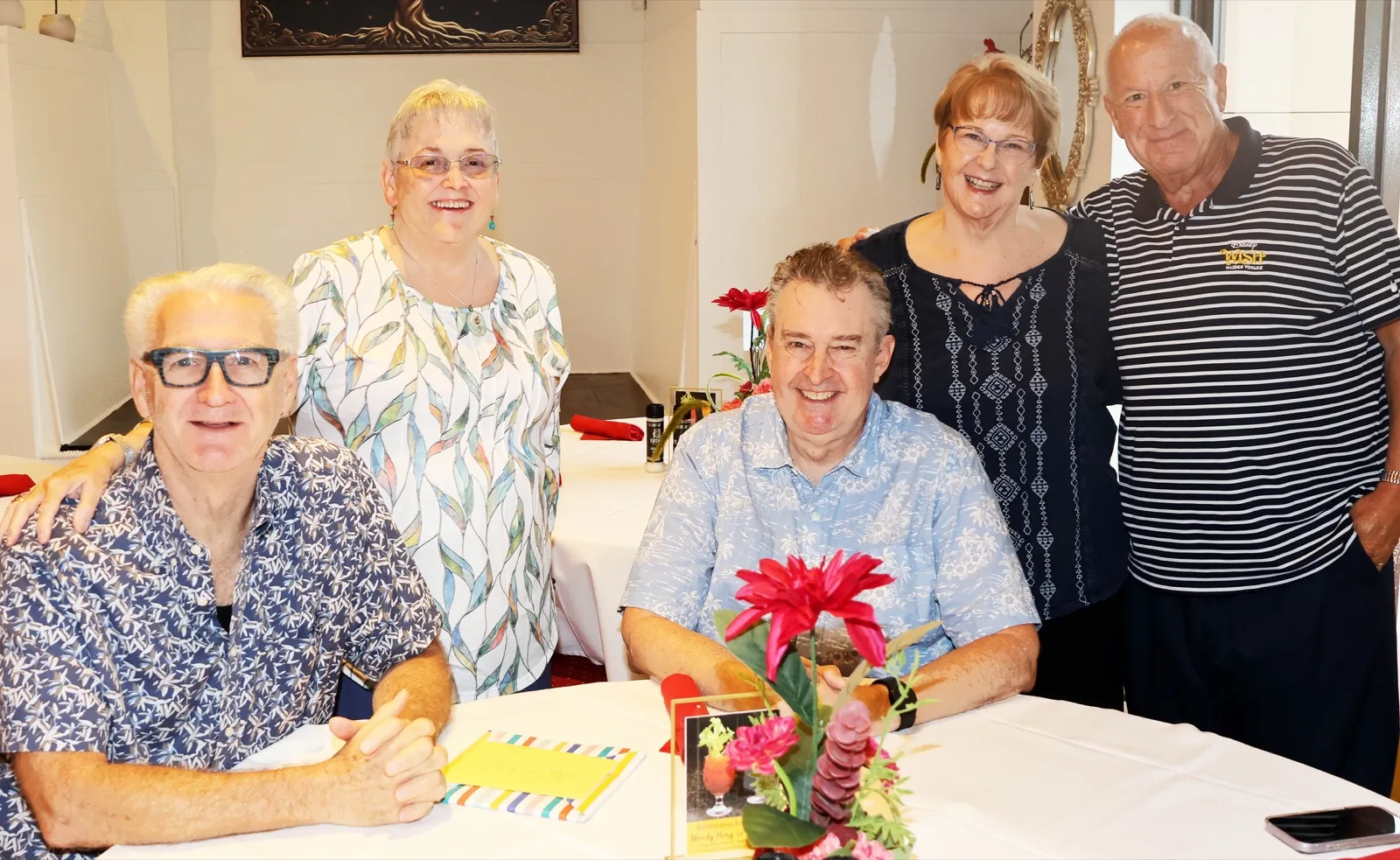 Guests seated and standing around a Sunday brunch table at The Venue Clermont